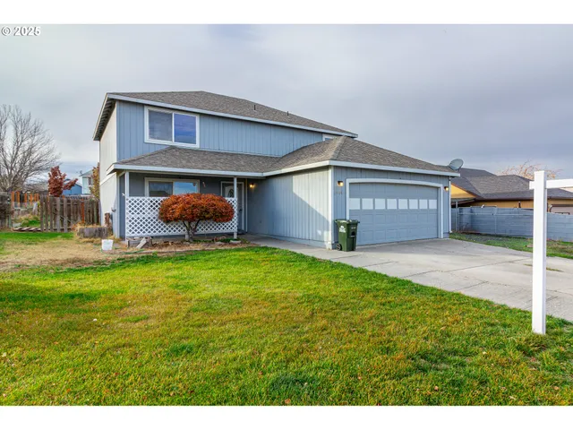 a kitchen with stainless steel appliances granite countertop a sink dishwasher stove and microwave with wooden cabinets