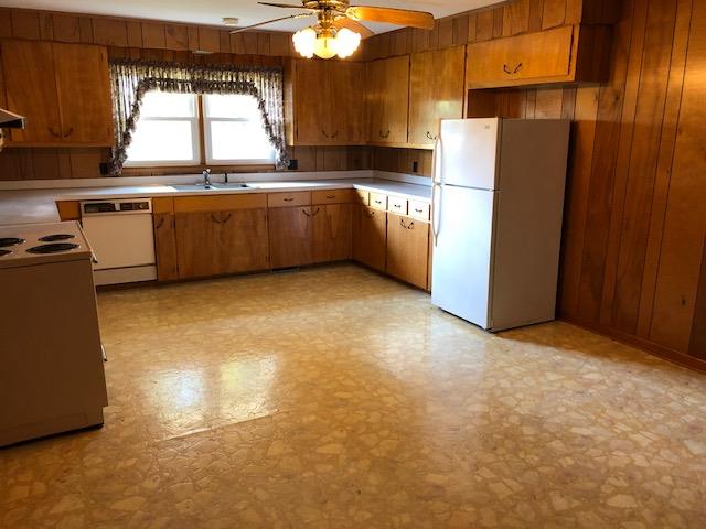 200 Tarpley Shop Road Pulaski, TN 38478 - Photo 8 of 19 a kitchen with stainless steel appliances granite countertop a refrigerator a sink a stove and island