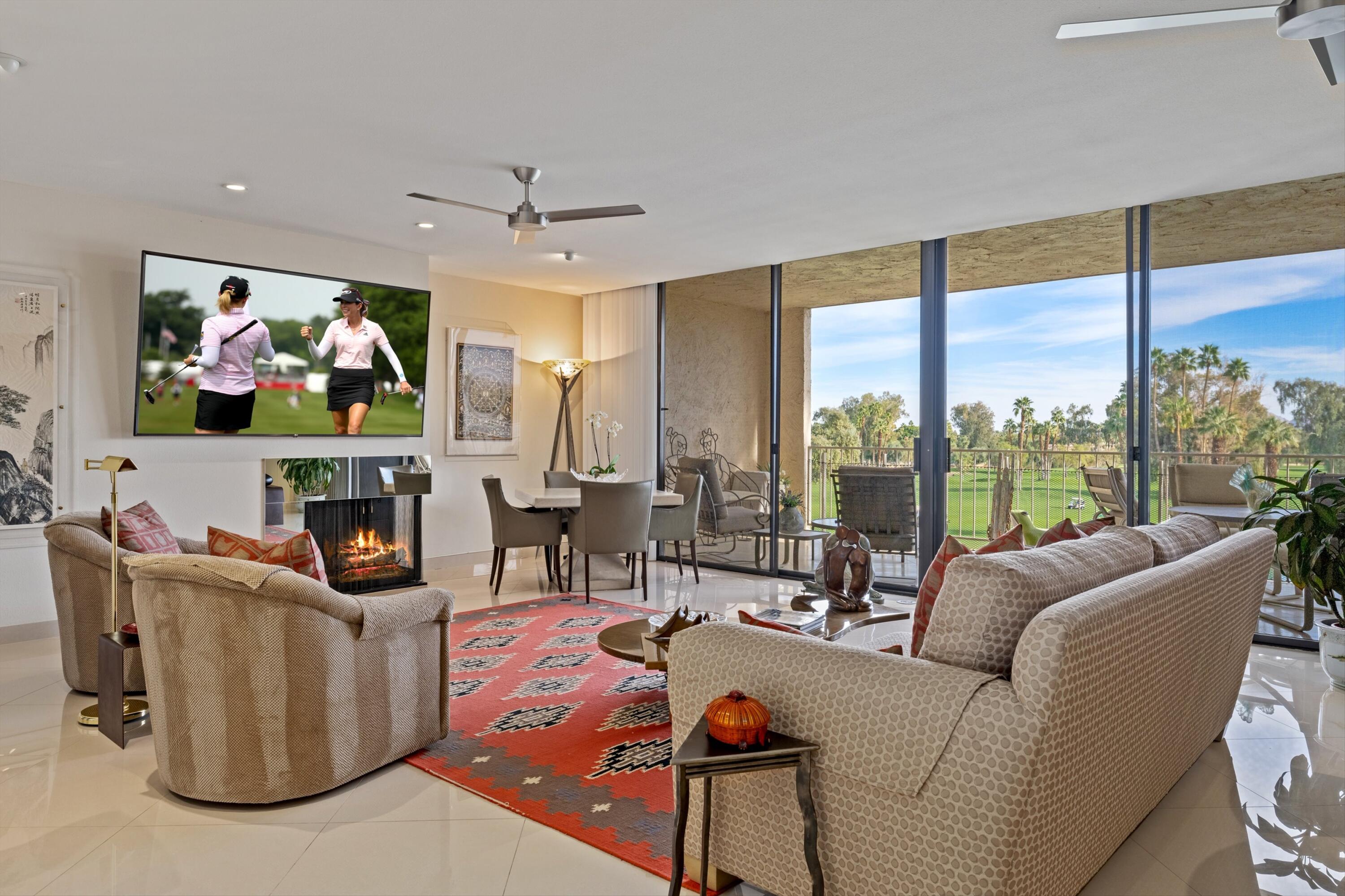 910 Island Drive, Unit 405 Rancho Mirage, CA 92270 - Photo 11 of 33 a living room with fireplace furniture and a flat screen tv
