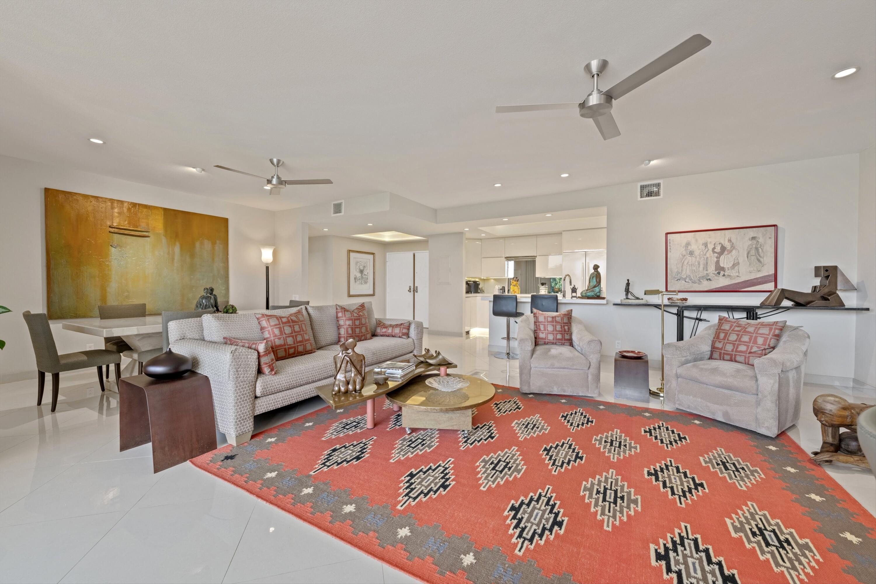 910 Island Drive, Unit 405 Rancho Mirage, CA 92270 - Photo 13 of 33 a living room with lots of furniture and gym equipment