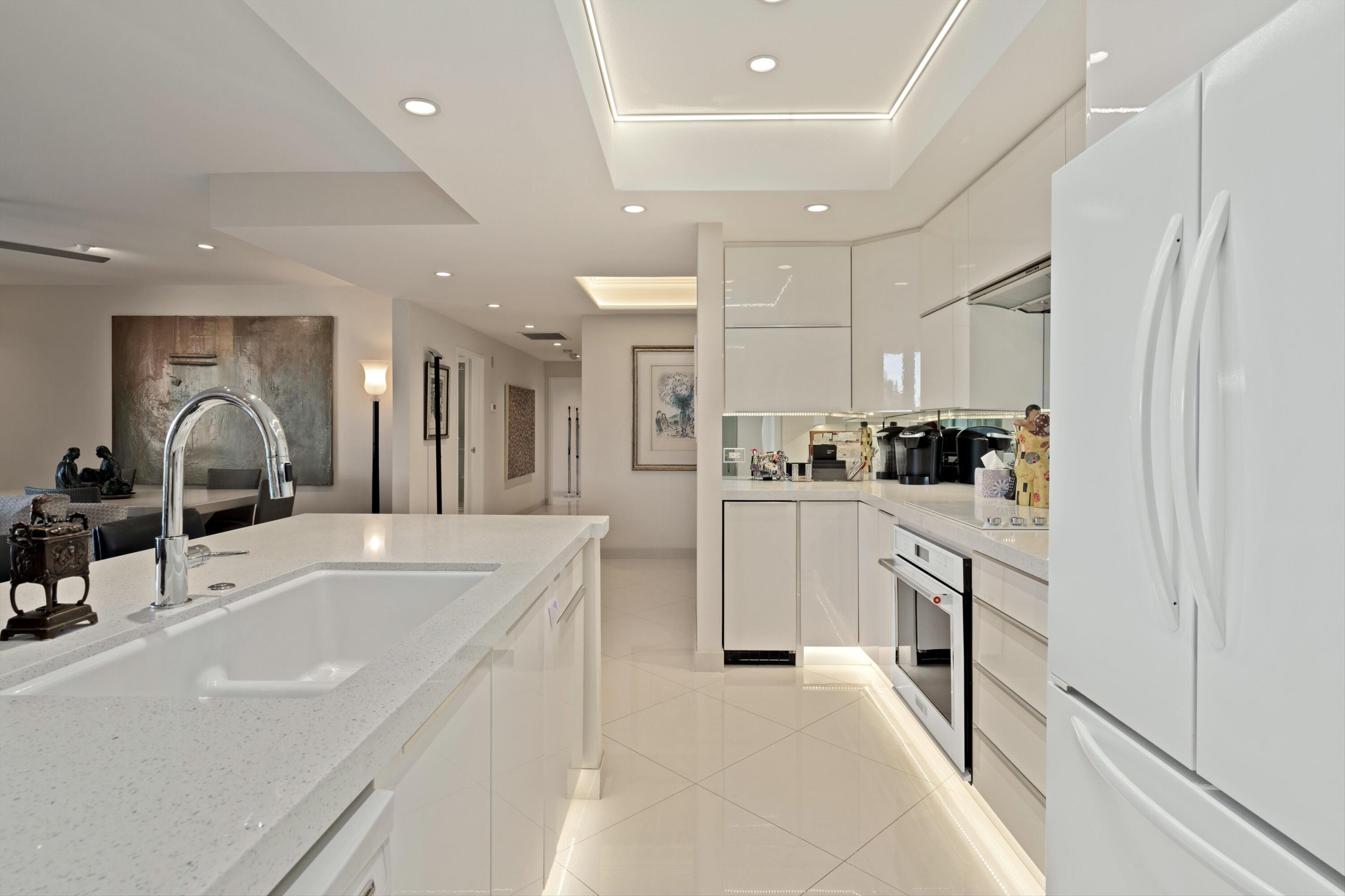 910 Island Drive, Unit 405 Rancho Mirage, CA 92270 - Photo 15 of 33 a kitchen with white cabinets and refrigerator