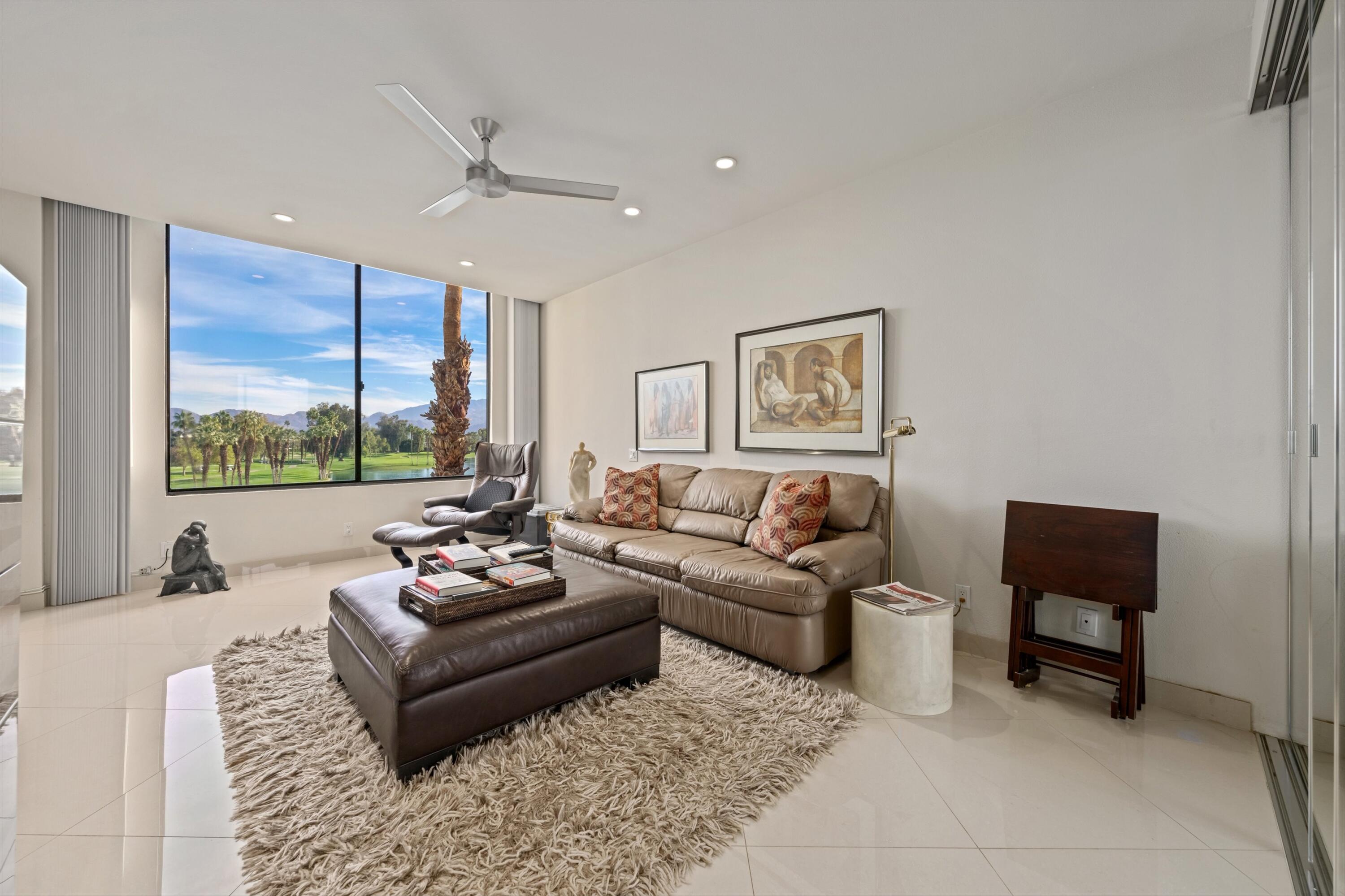 910 Island Drive, Unit 405 Rancho Mirage, CA 92270 - Photo 18 of 33 a living room with furniture and a large window