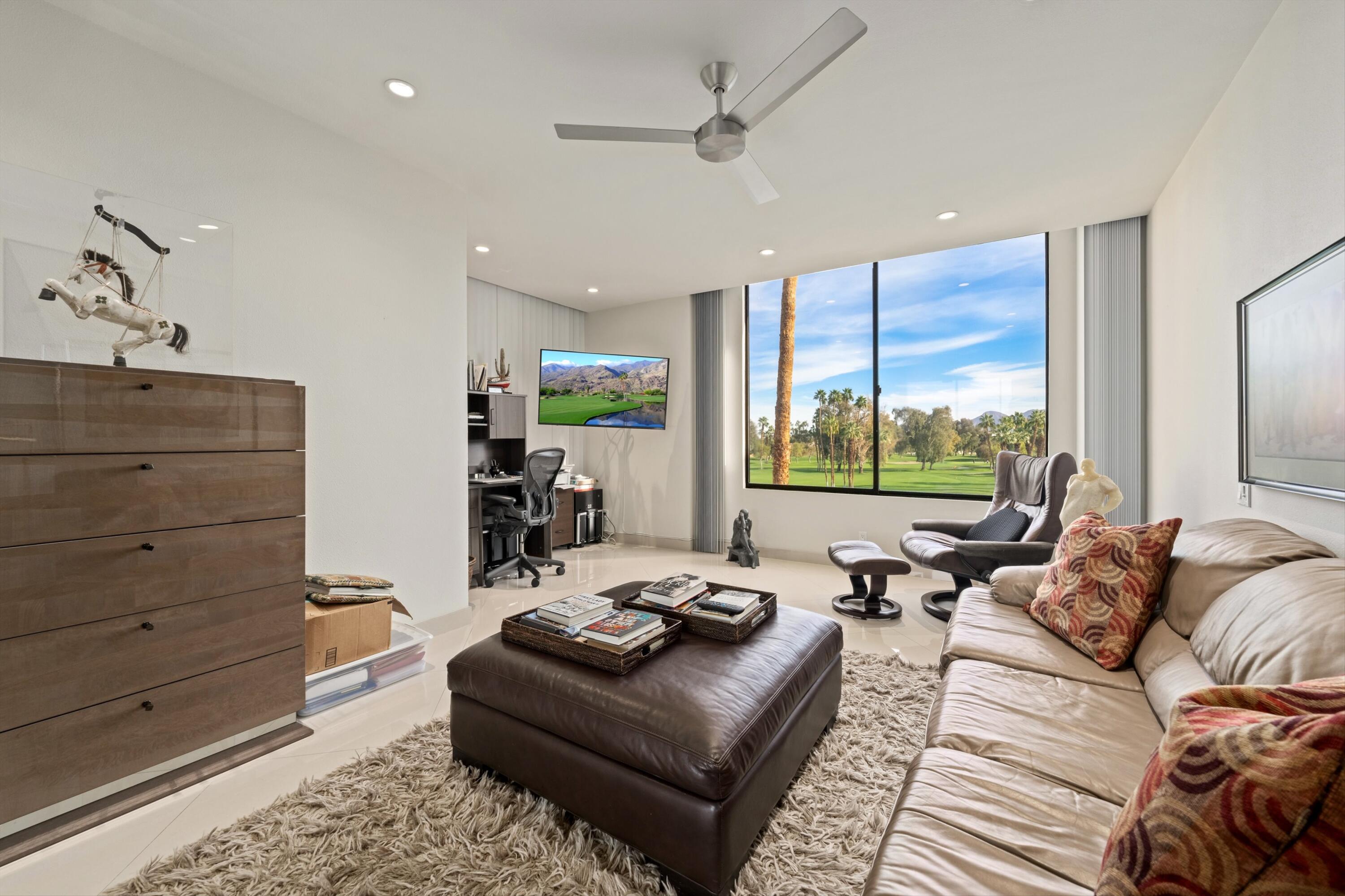 910 Island Drive, Unit 405 Rancho Mirage, CA 92270 - Photo 19 of 33 a living room with furniture and large windows