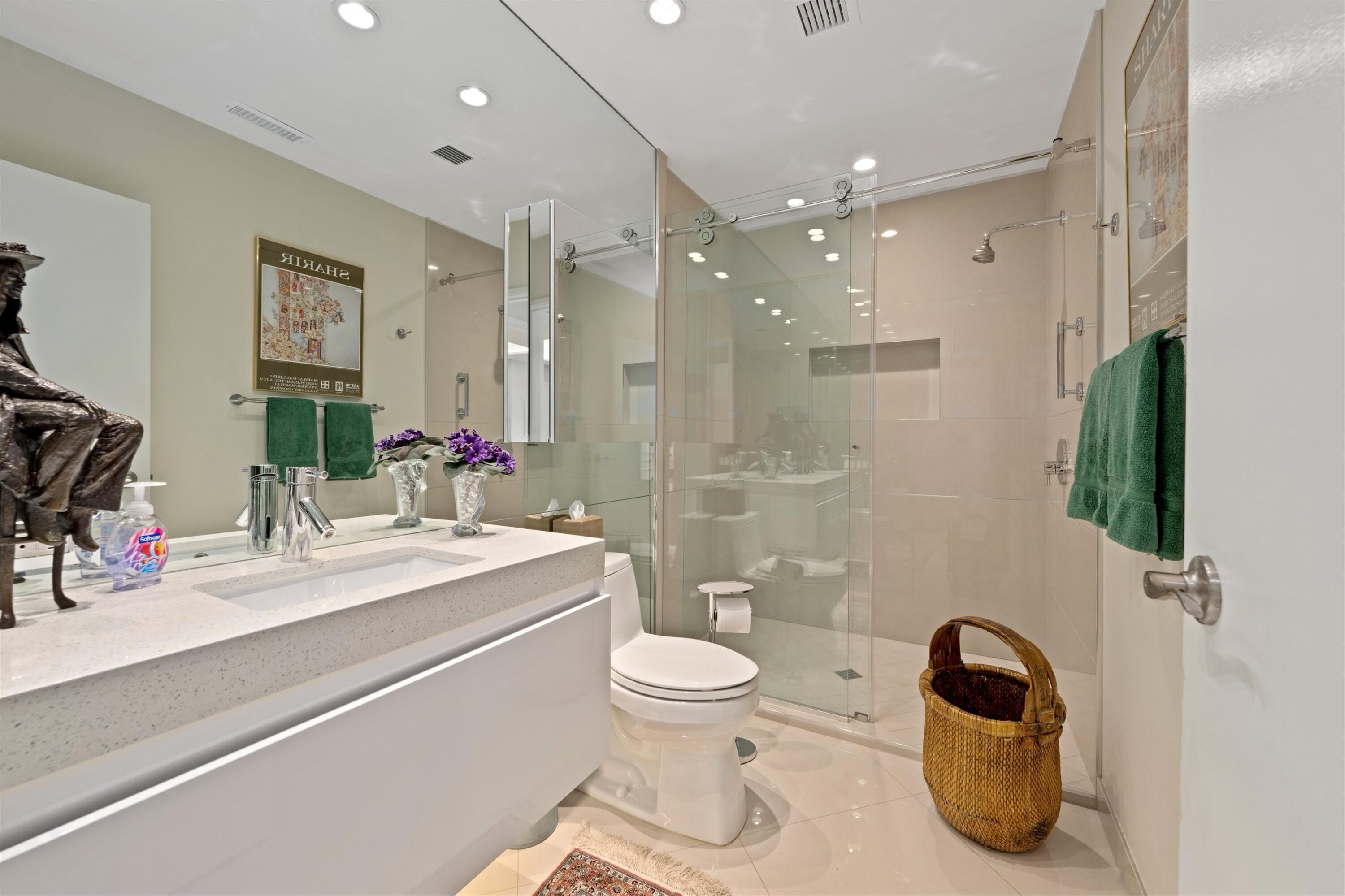 910 Island Drive, Unit 405 Rancho Mirage, CA 92270 - Photo 20 of 33 a bathroom with a sink a toilet and shower