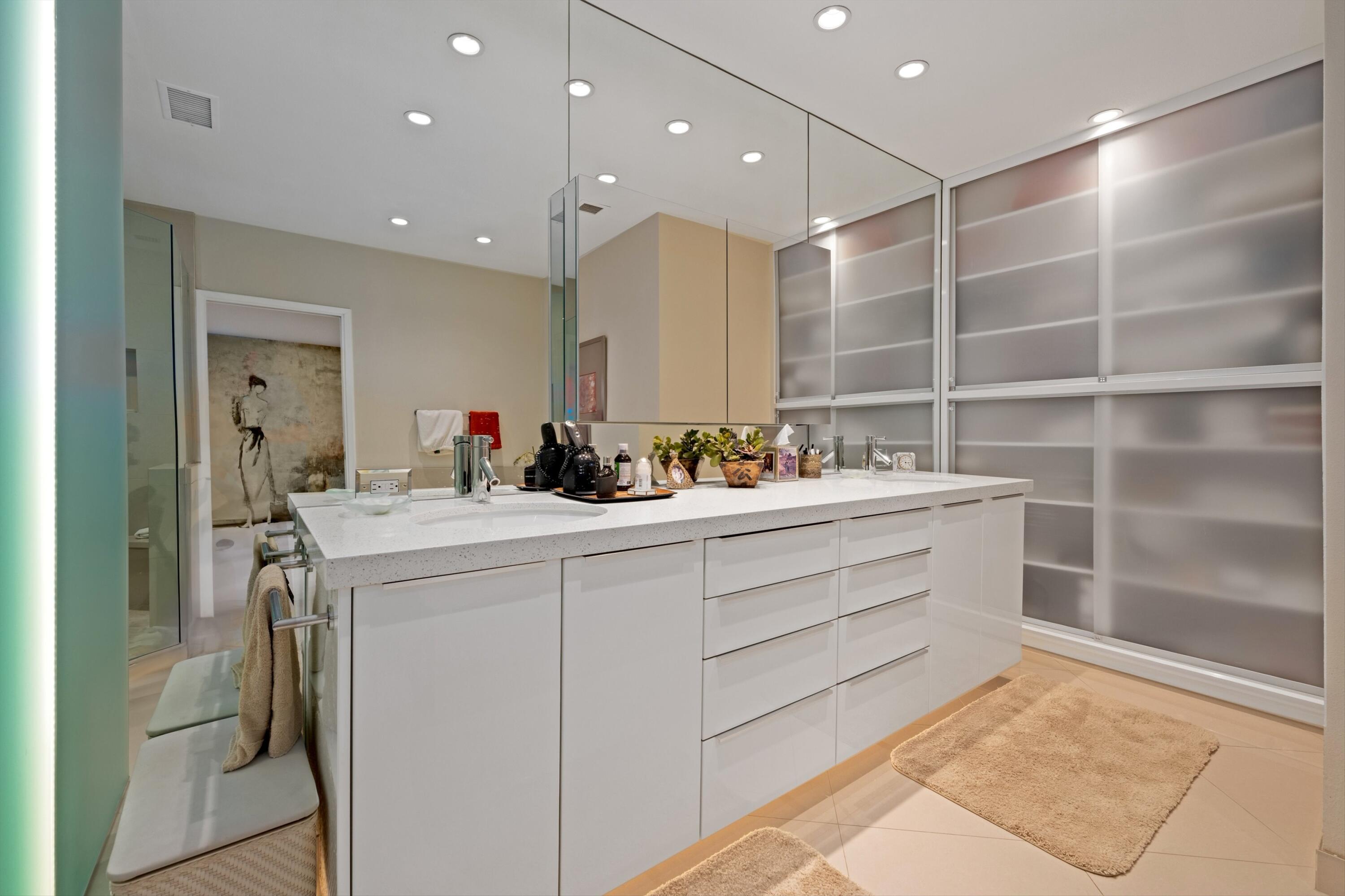 910 Island Drive, Unit 405 Rancho Mirage, CA 92270 - Photo 22 of 33 a bathroom with a sink double vanity and a mirror