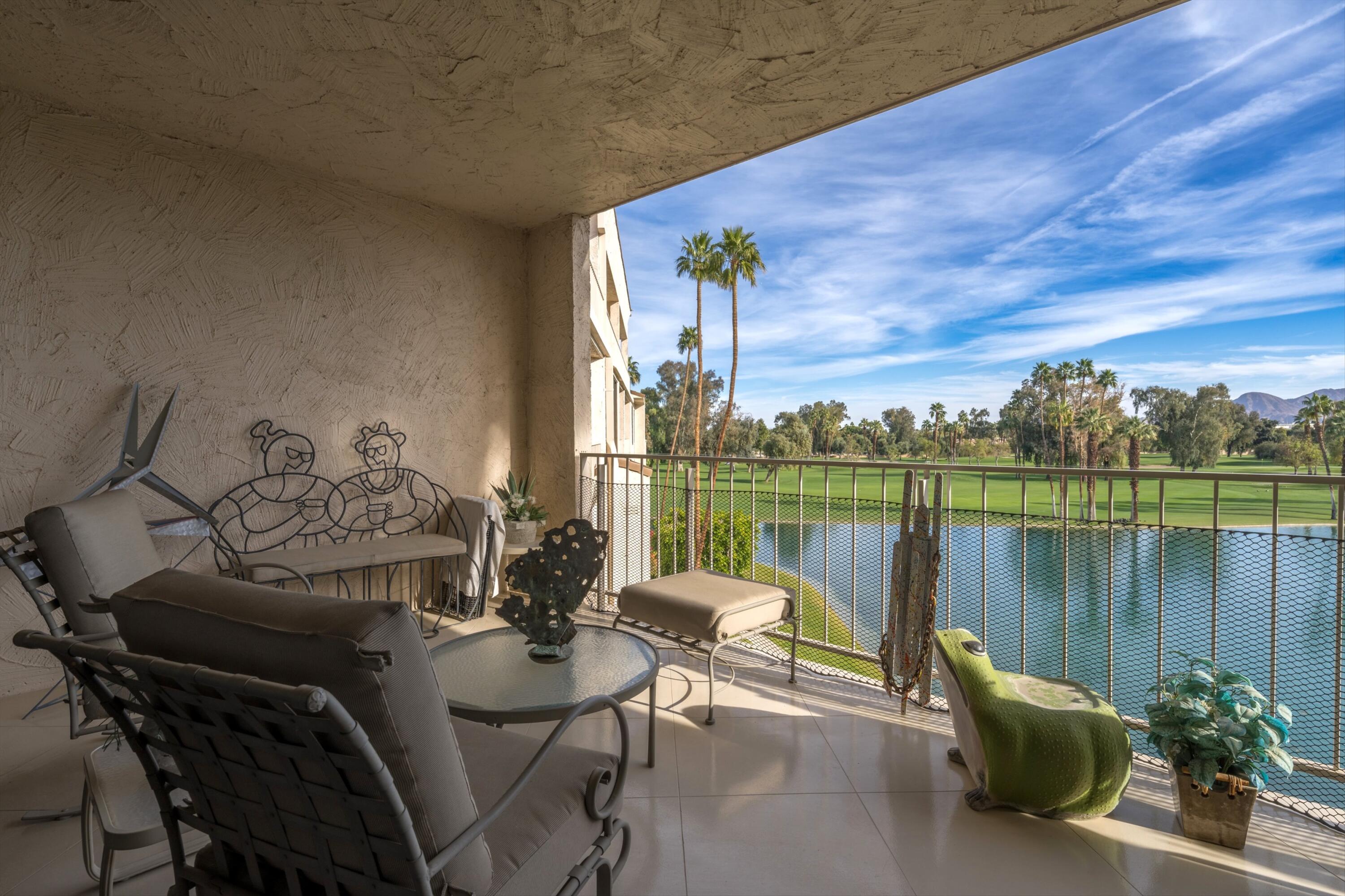 910 Island Drive, Unit 405 Rancho Mirage, CA 92270 - Photo 3 of 33 a view of a balcony with lake view and a potted plant