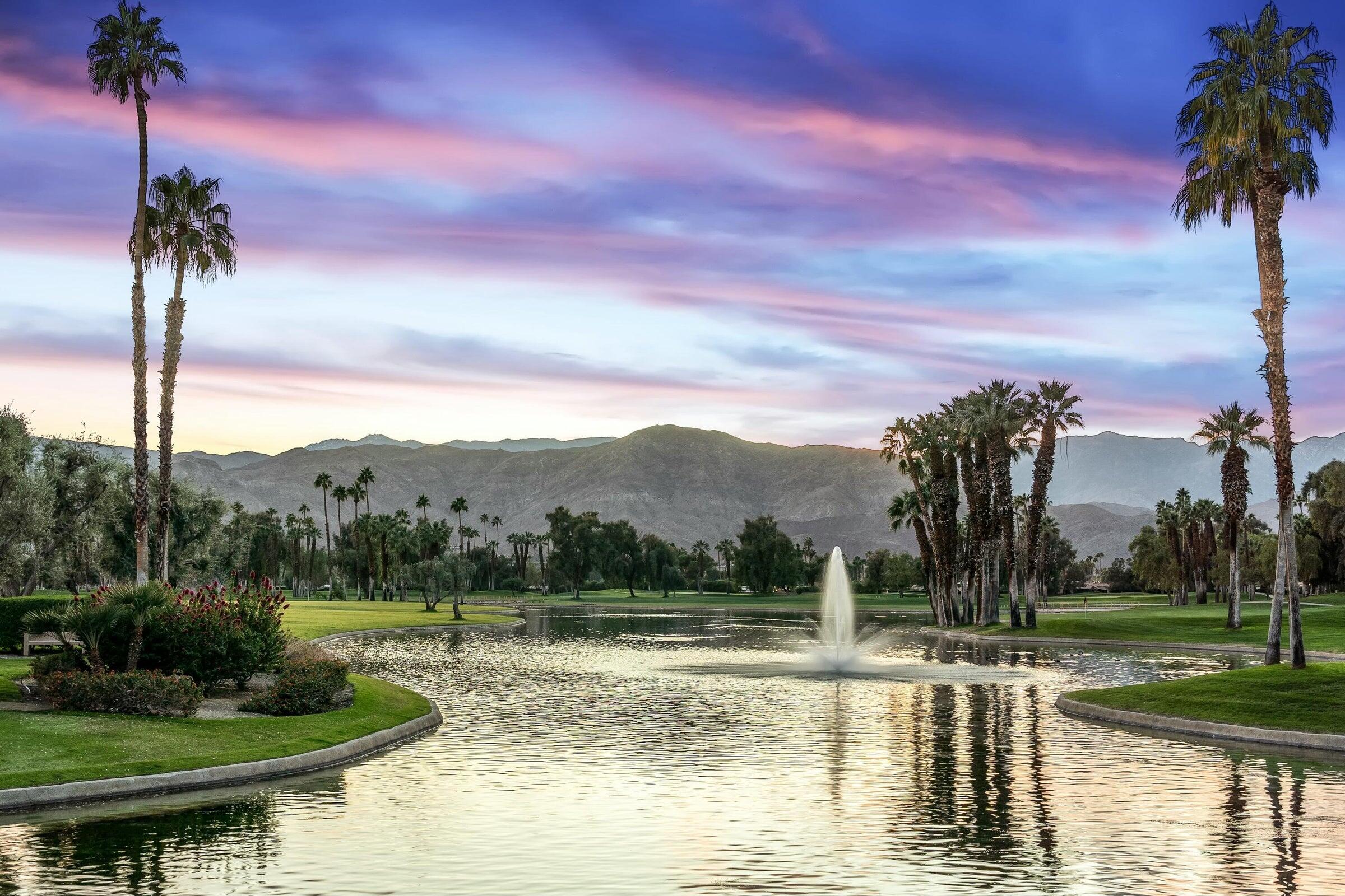 910 Island Drive, Unit 405 Rancho Mirage, CA 92270 - Photo 31 of 33 a view of a lake with a house in the background