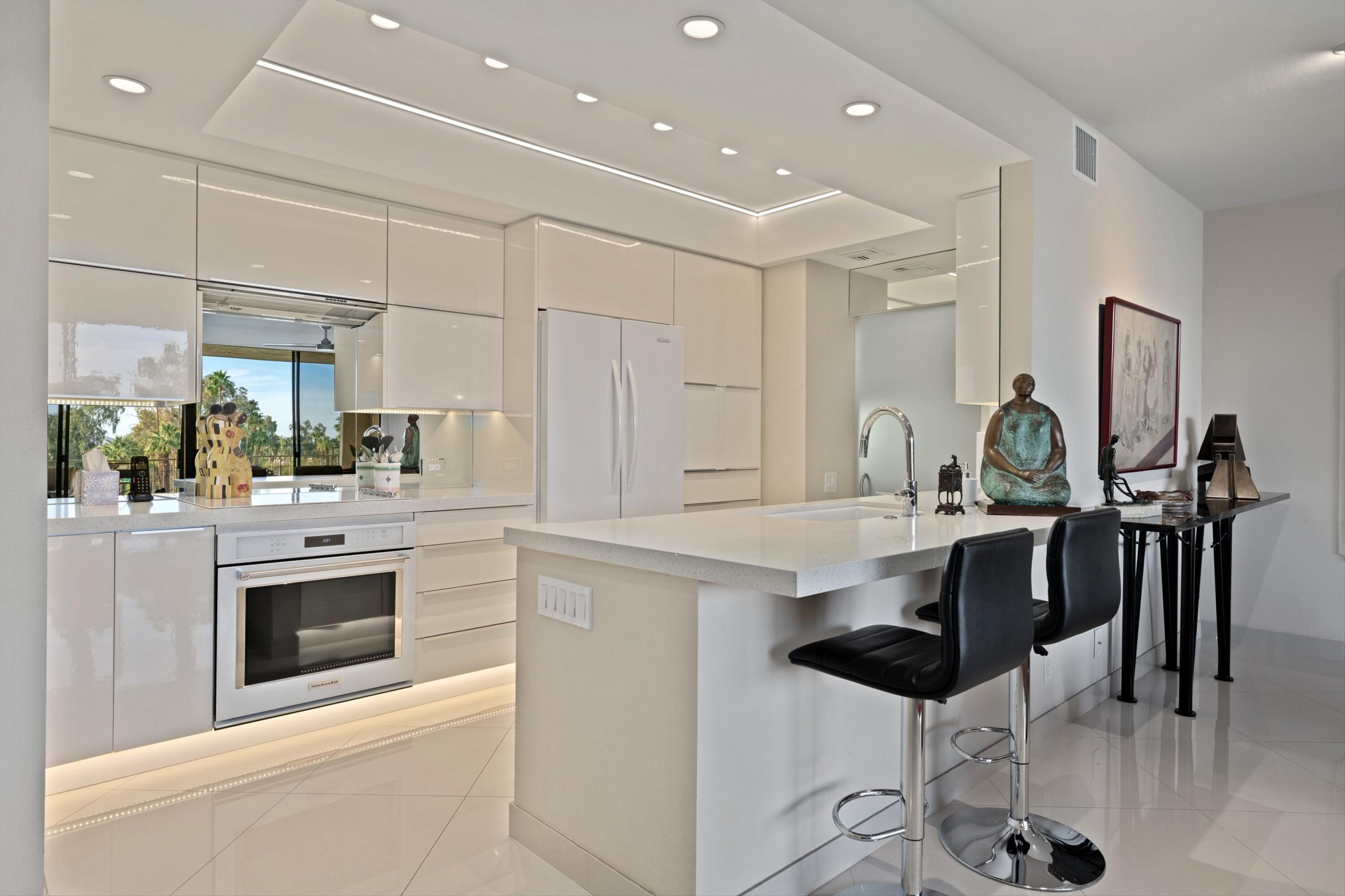 910 Island Drive, Unit 405 Rancho Mirage, CA 92270 - Photo 6 of 33 a kitchen with stainless steel appliances kitchen island granite countertop a stove and a cabinets