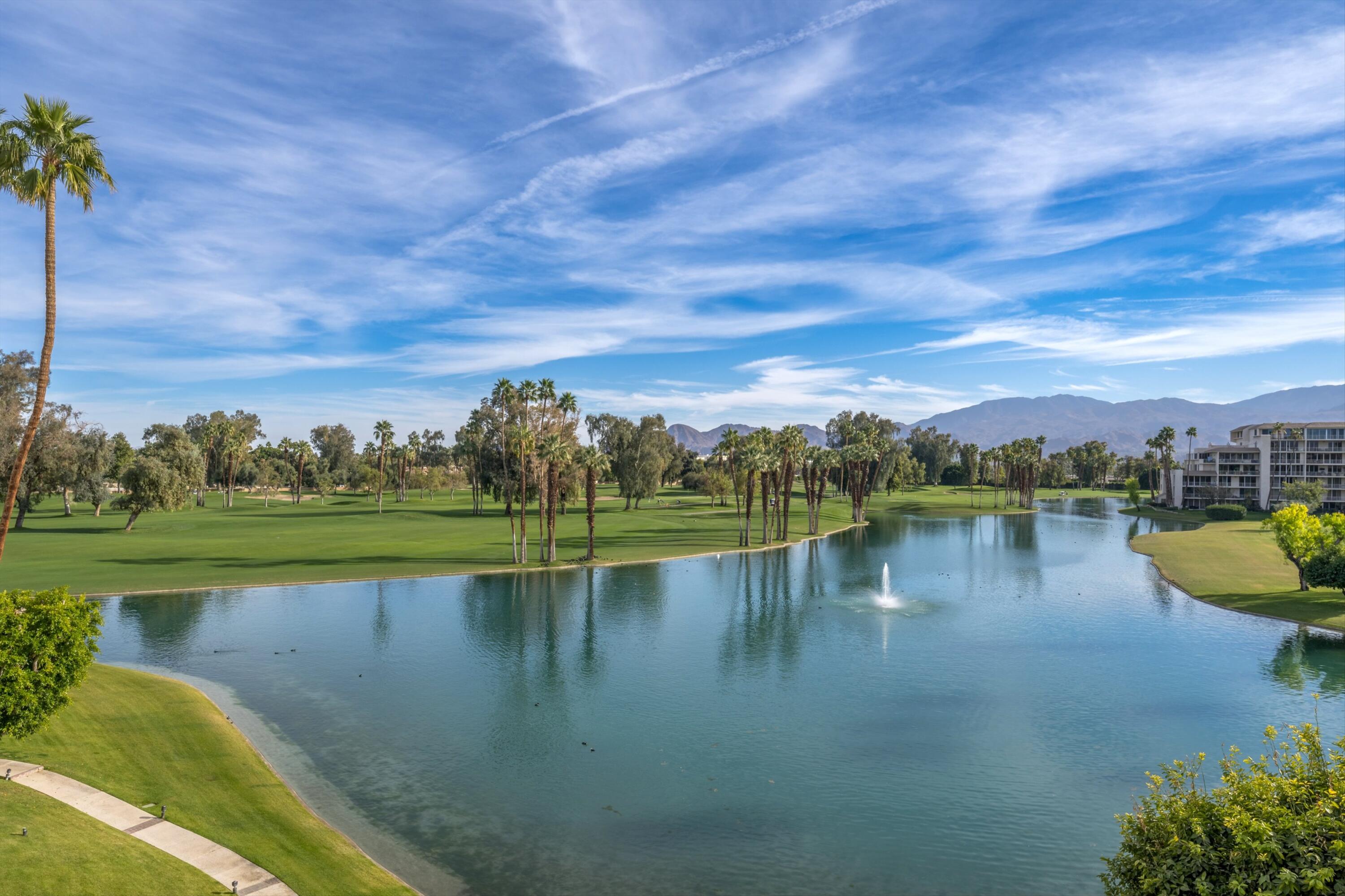 910 Island Drive, Unit 405 Rancho Mirage, CA 92270 - Photo 9 of 33 a view of a lake with a yard