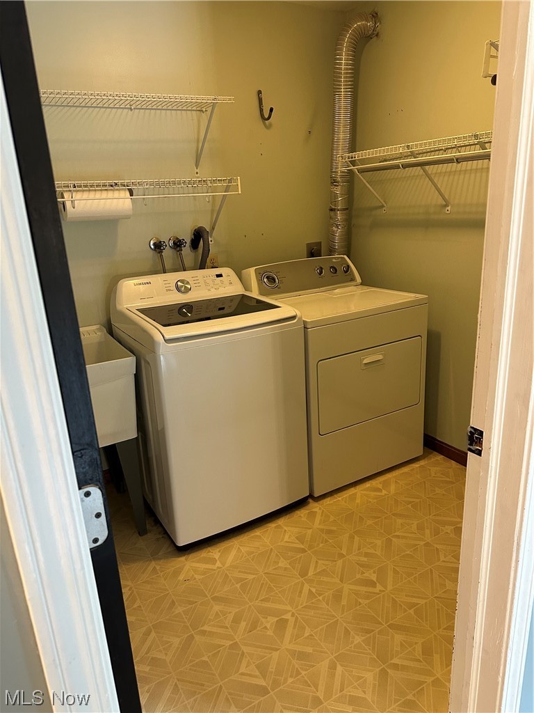 6715 Crosse Road Amherst, OH 44001 - Photo 6 of 21 Laundry area featuring light tile flooring and washer and dryer