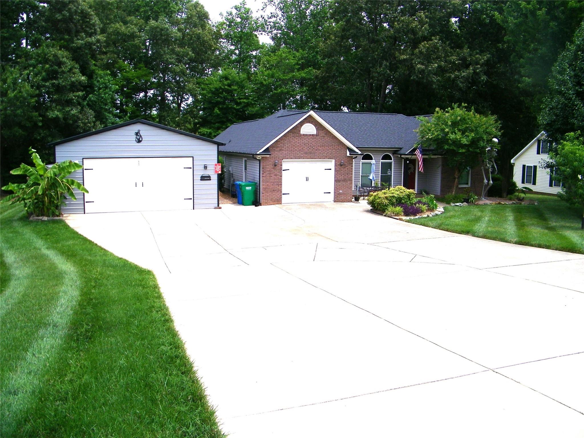 609 Redah Avenue Locust, NC 28097 - Photo 37 of 37 a front view of a house with a yard and garage