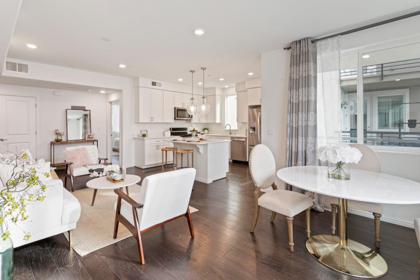 a view of a dining room with furniture and wooden floor