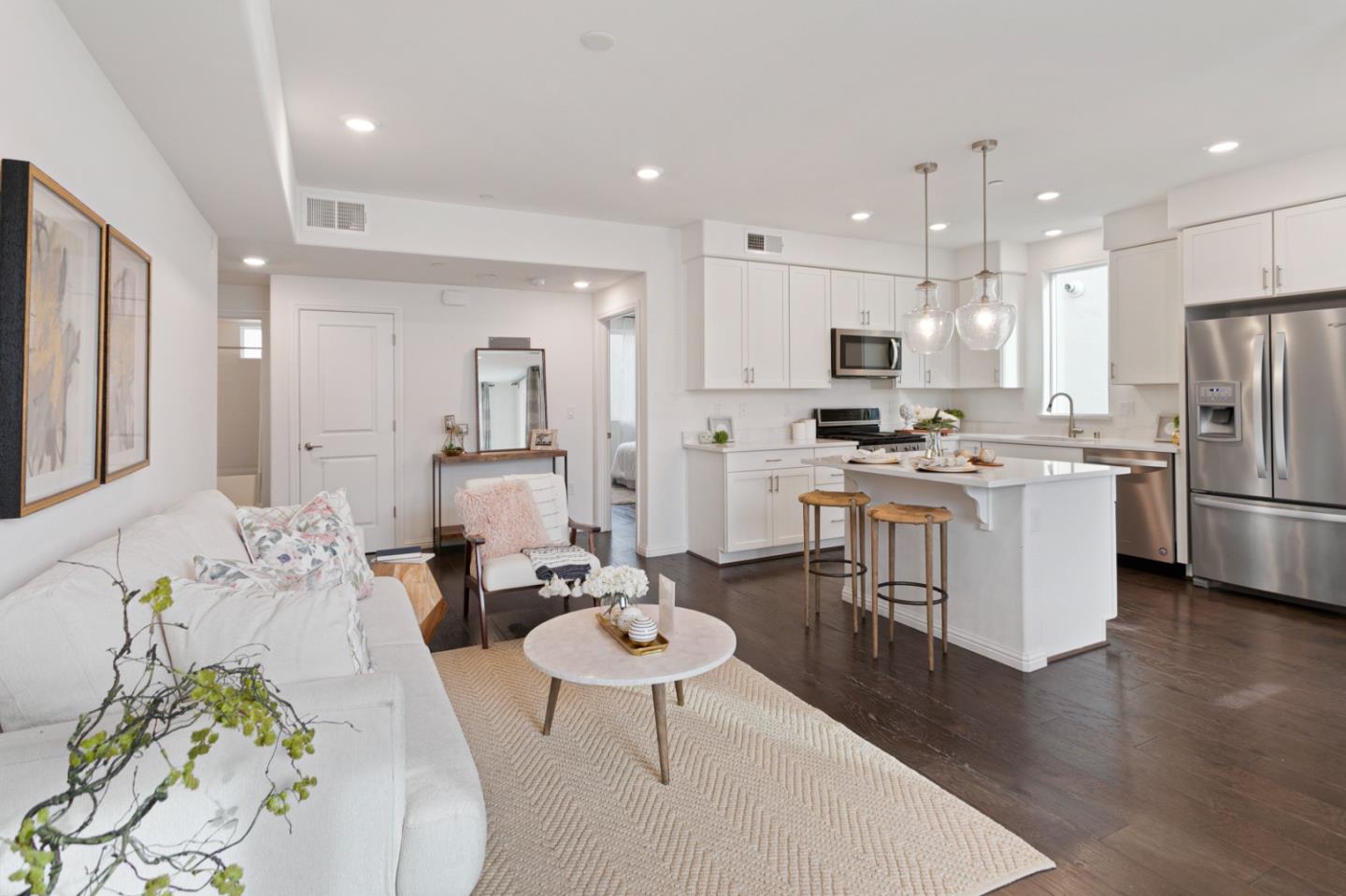 1435 Nightshade Road, Unit 30 Milpitas, CA 95035 - Photo 2 of 16 a kitchen with stainless steel appliances kitchen island granite countertop a dining table chairs refrigerator sink and cabinets