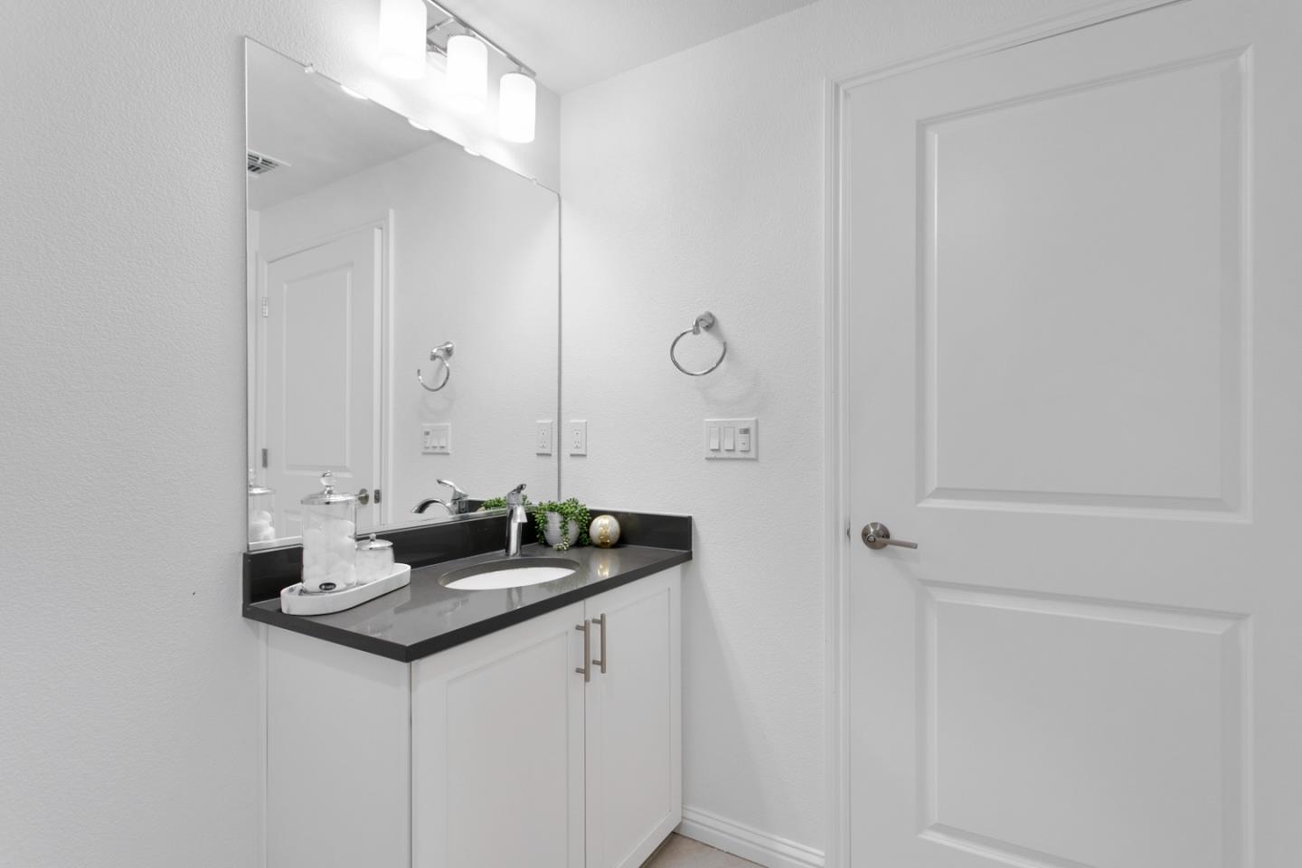 1435 Nightshade Road, Unit 30 Milpitas, CA 95035 - Photo 11 of 16 a bathroom with a granite countertop sink and a mirror
