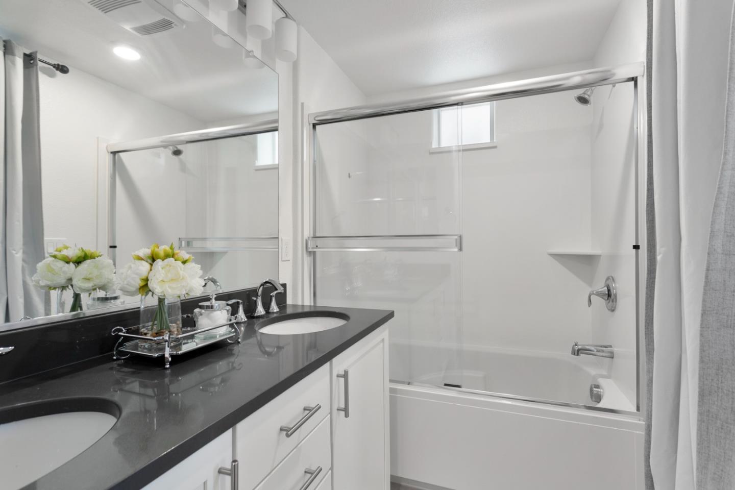 1435 Nightshade Road, Unit 30 Milpitas, CA 95035 - Photo 8 of 16 a bathroom with a granite countertop sink a mirror and a shower