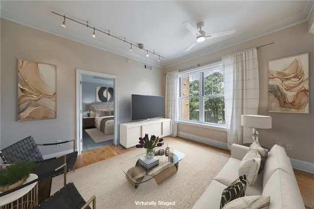 a living room with furniture couches and a flat screen tv