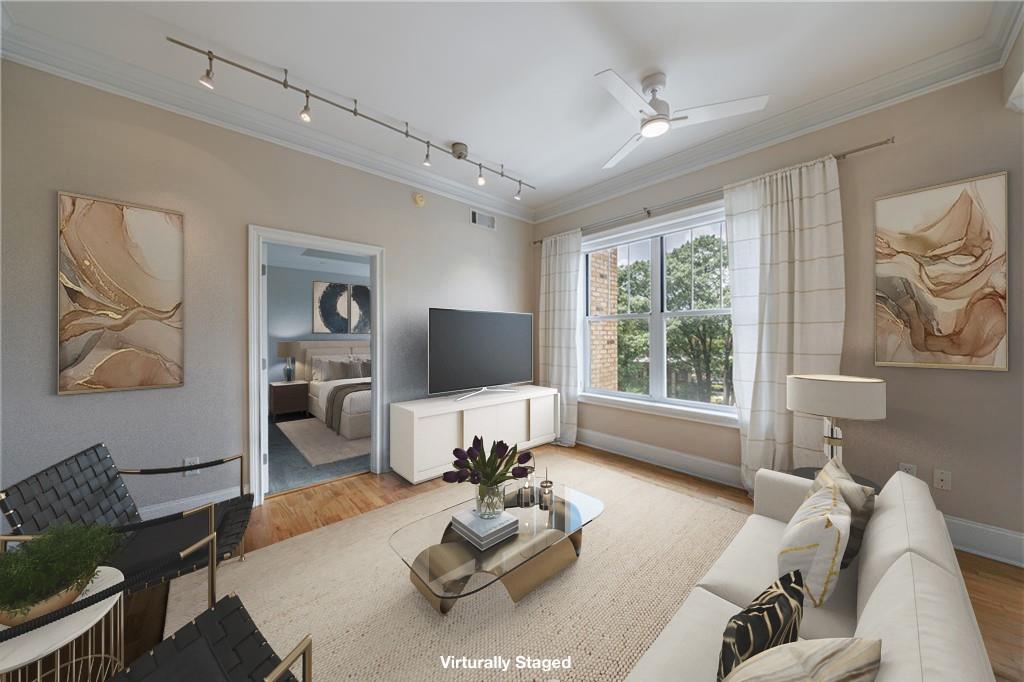 a living room with furniture couches and a flat screen tv