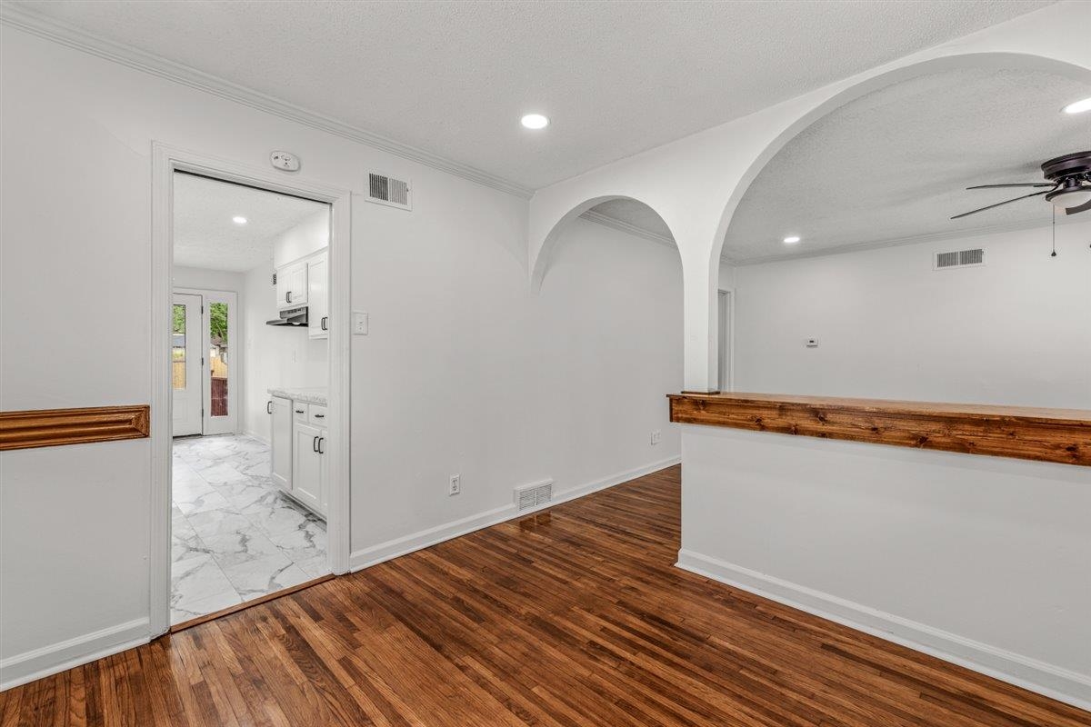 1244 Wells Station Road Memphis, TN 38122 - Photo 12 of 36 Spare room with arched walkways, ceiling fan, light wood finished floors, recessed lighting, and a textured ceiling