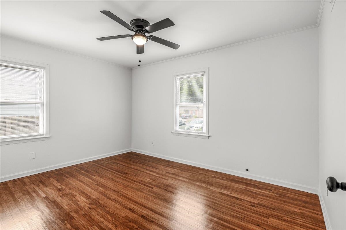 1244 Wells Station Road Memphis, TN 38122 - Photo 20 of 36 Unfurnished room with dark wood-style flooring, ornamental molding, and ceiling fan