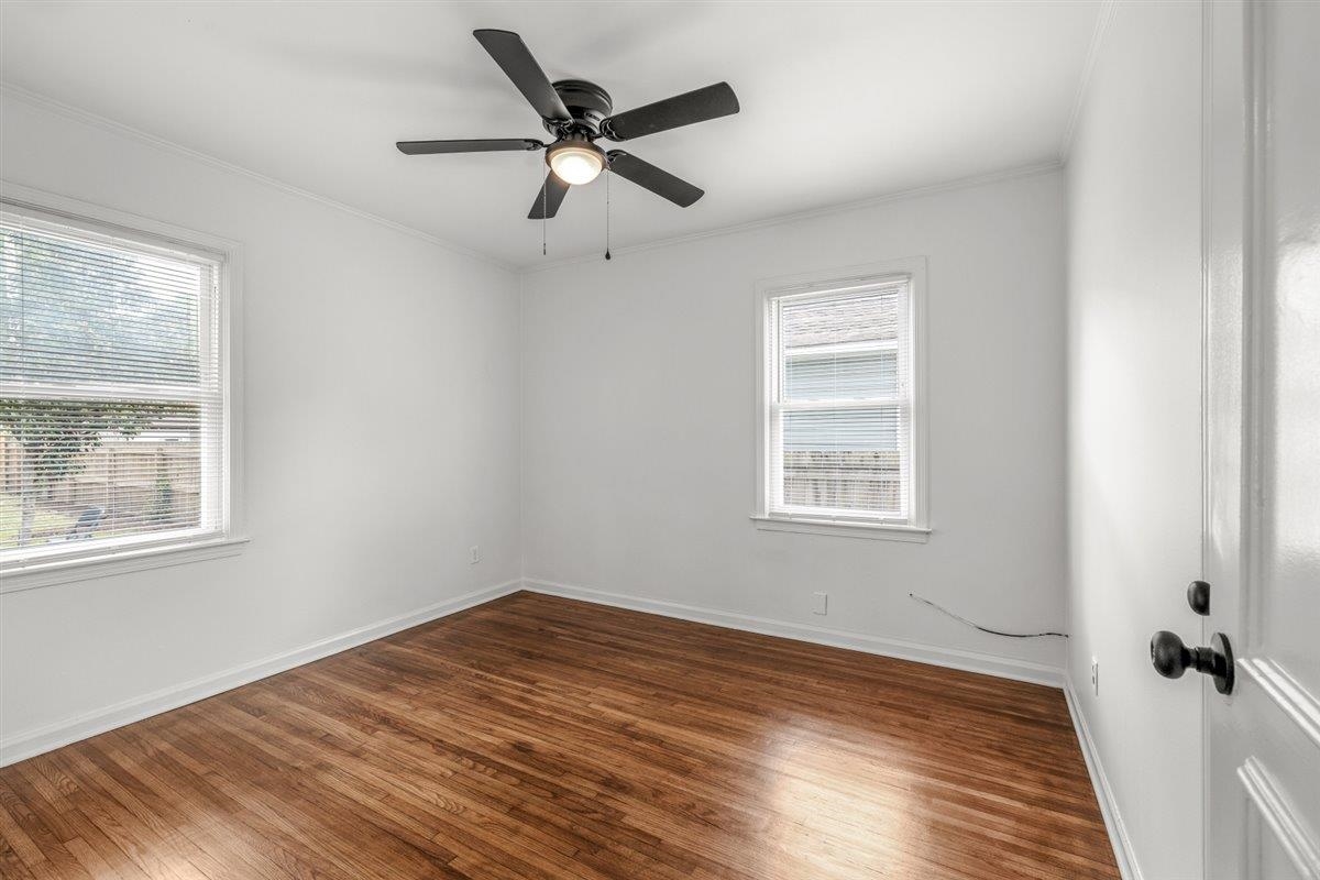 1244 Wells Station Road Memphis, TN 38122 - Photo 23 of 36 Spare room with dark wood-style floors, ceiling fan, and ornamental molding