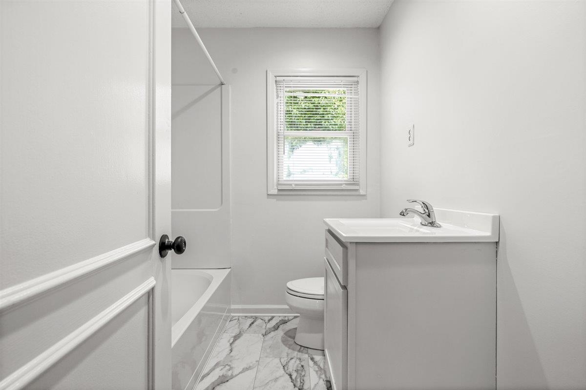 1244 Wells Station Road Memphis, TN 38122 - Photo 31 of 36 Bathroom featuring vanity, light marble finish flooring, and shower / bathtub combination