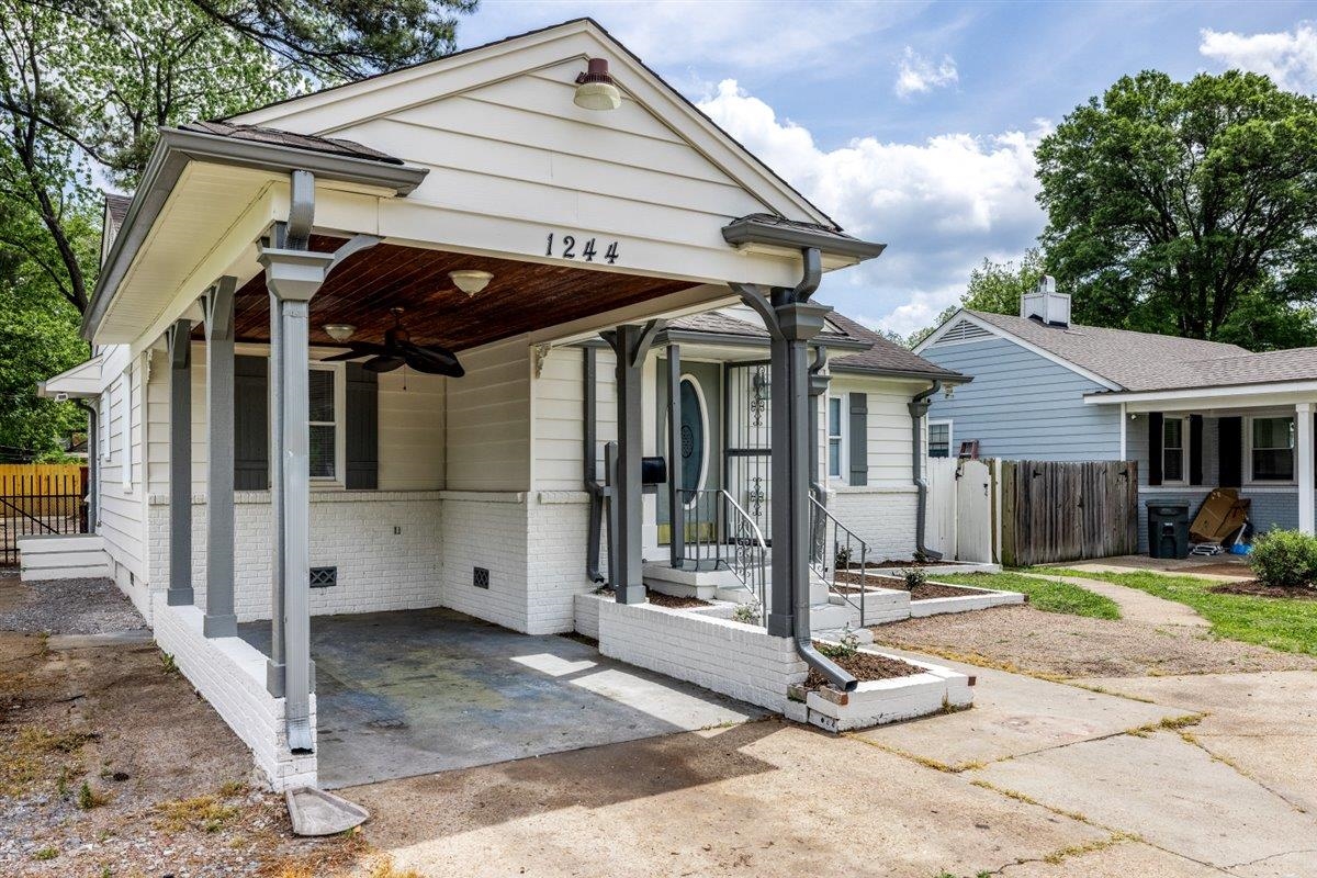 1244 Wells Station Road Memphis, TN 38122 - Photo 36 of 36 View of front of property featuring brick siding, a ceiling fan, a gate, and an attached carport
