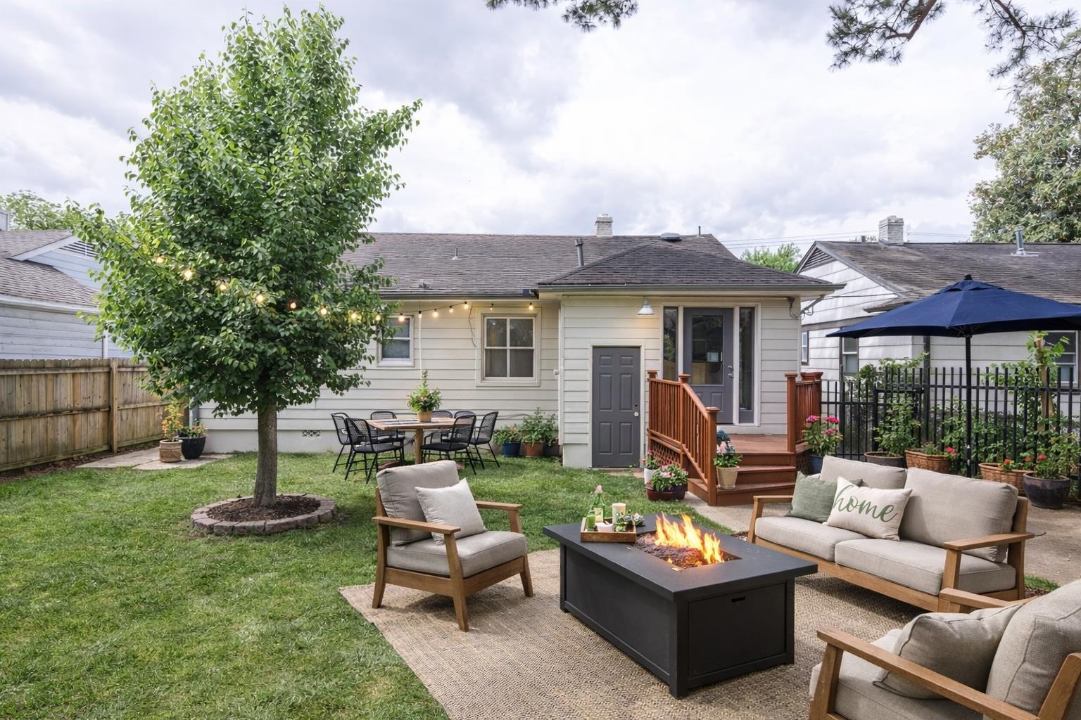 1244 Wells Station Road Memphis, TN 38122 - Photo 4 of 36 Rear view of property featuring a patio area, a fenced backyard, outdoor lounge area, and a fire pit