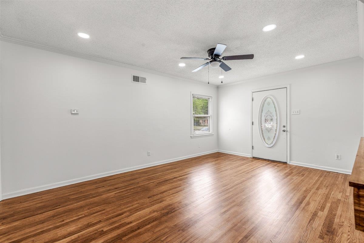 1244 Wells Station Road Memphis, TN 38122 - Photo 10 of 36 Empty room featuring wood finished floors, a textured ceiling, ceiling fan, and recessed lighting
