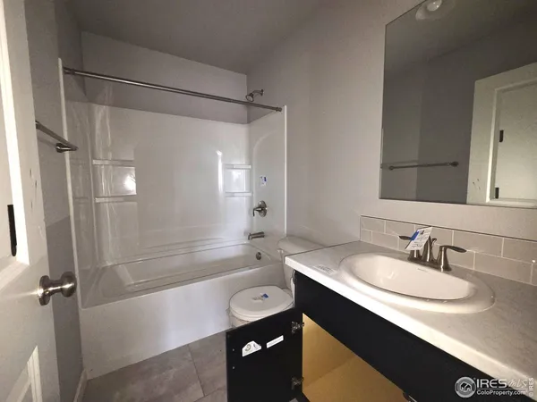 a bathroom with a sink and a mirror with bathtub