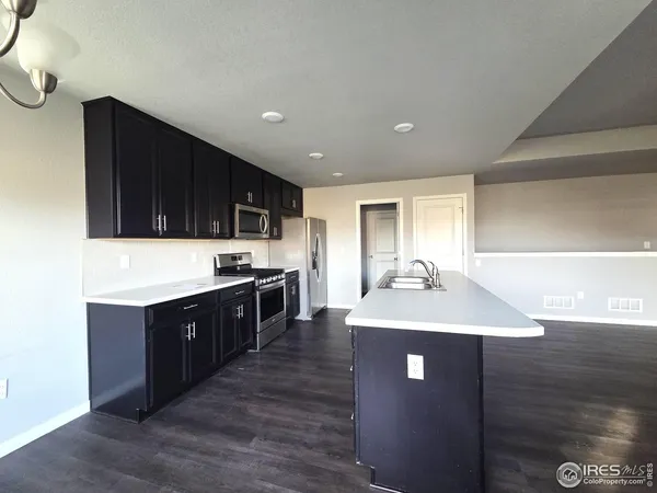 a kitchen with stainless steel appliances granite countertop a sink counter space and cabinets