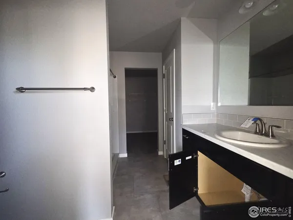 a kitchen with a sink a refrigerator and cabinets