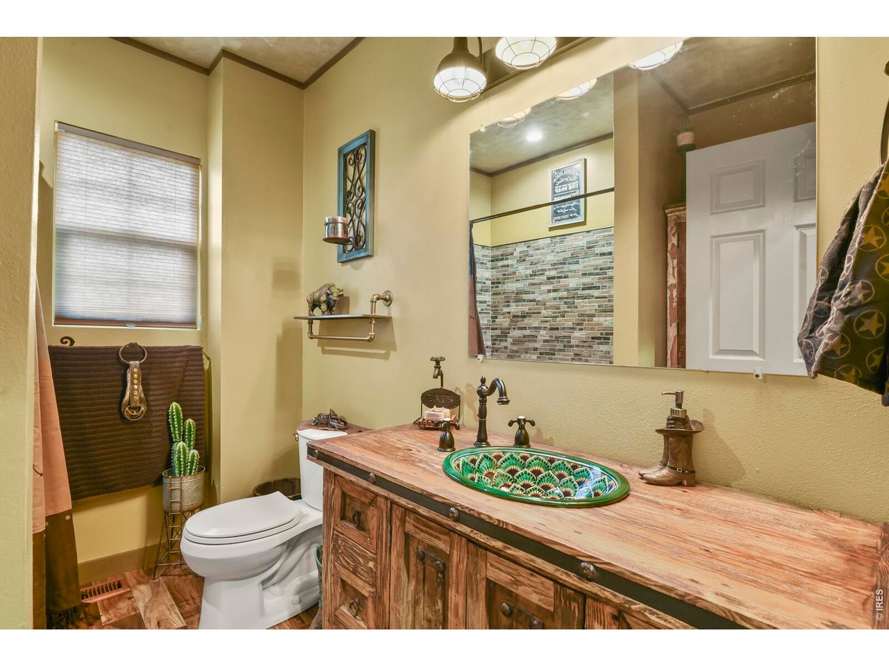 417 2nd Street Fort Lupton, CO 80621 - Photo 17 of 24 a bathroom with a granite countertop toilet sink and mirror