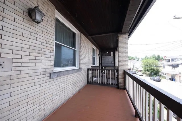 a view of a balcony with wooden floor