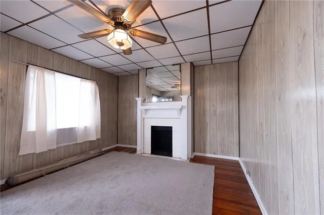 a view of an empty room with a fireplace and a window