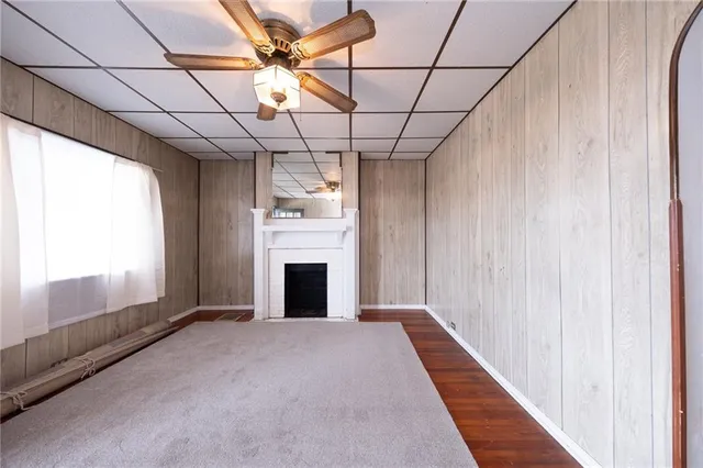 a view of empty room with fireplace and fan