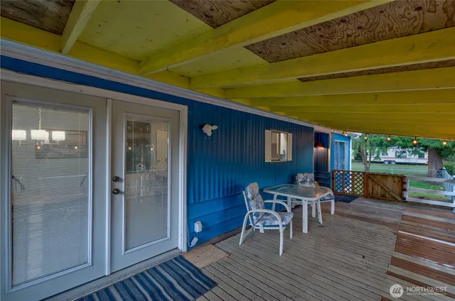 a view of a house with a yard and wooden fence