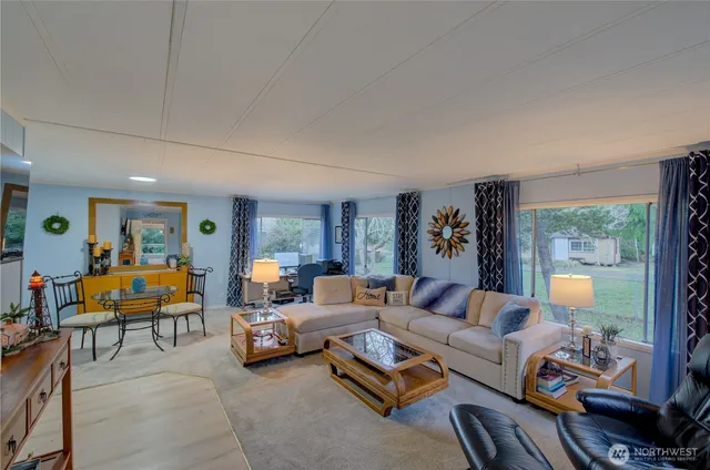 a living room with furniture gym equipment and a large window