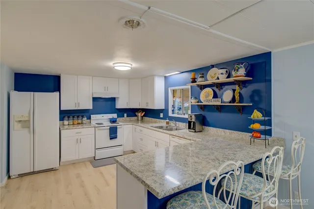 a spacious bathroom with double vanity a sink and a mirror