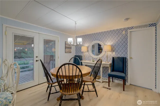 an open kitchen view with wooden floor and stainless steel appliances
