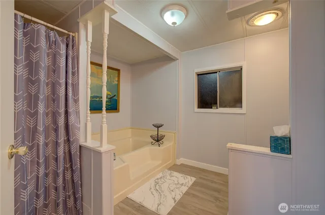 a bedroom with a bed and a refrigerator