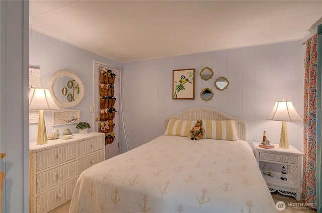 a en suite bathroom with a granite countertop sink and a mirror