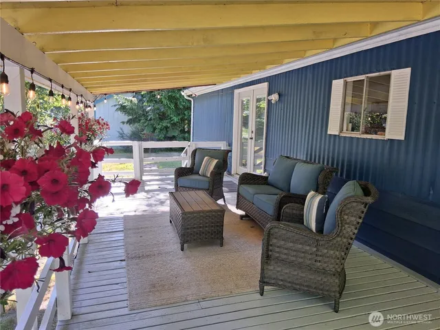 a patio with patio couch and potted plants
