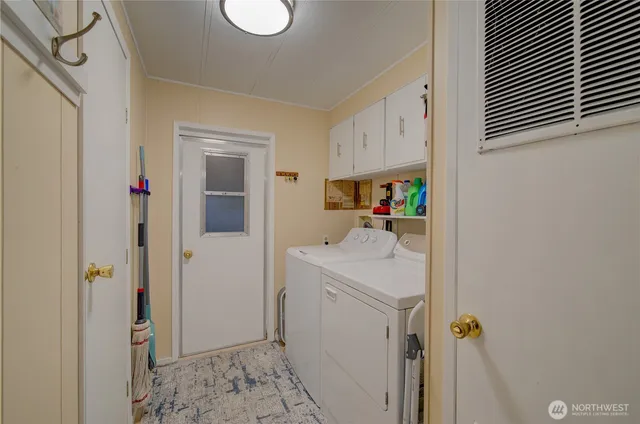 an aerial view of a house with a yard and a large tree