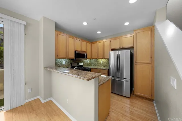a kitchen with a refrigerator sink and microwave