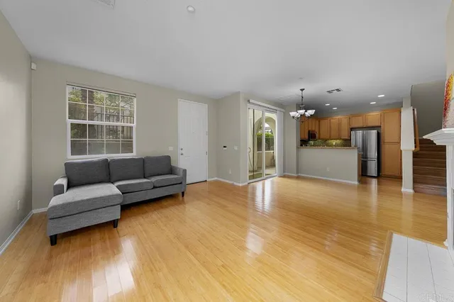 a living room with furniture and kitchen view