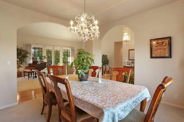 a living room with furniture a couch and a chandelier