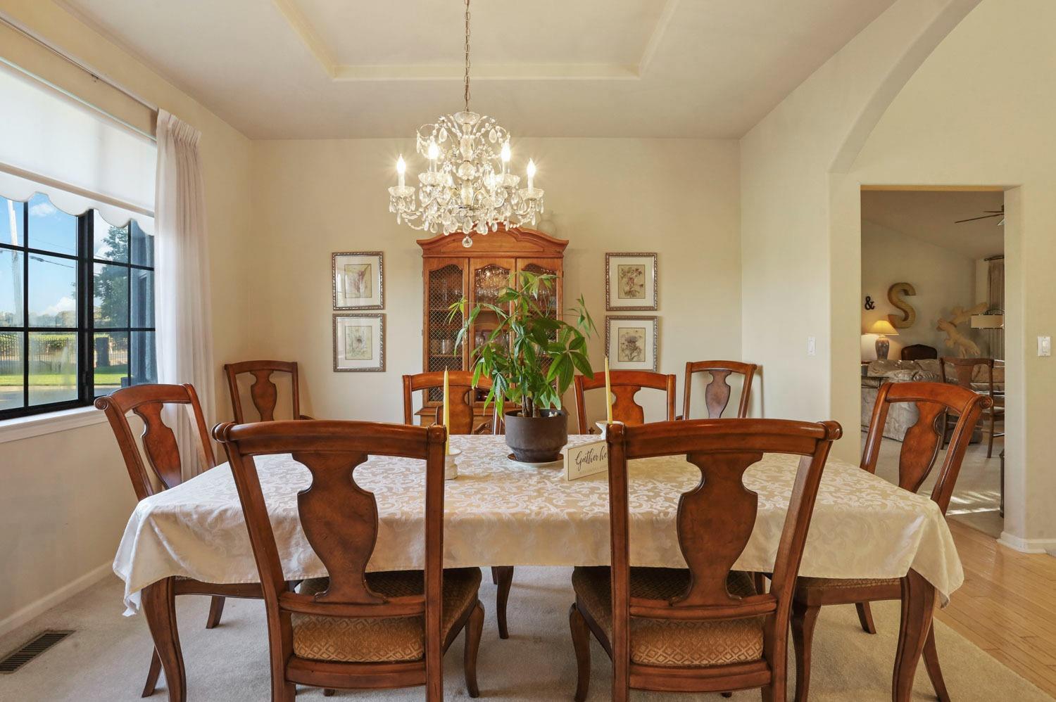 11791 Alpine Road Lodi, CA 95240 - Photo 17 of 74 a view of a dining room with furniture a chandelier and window