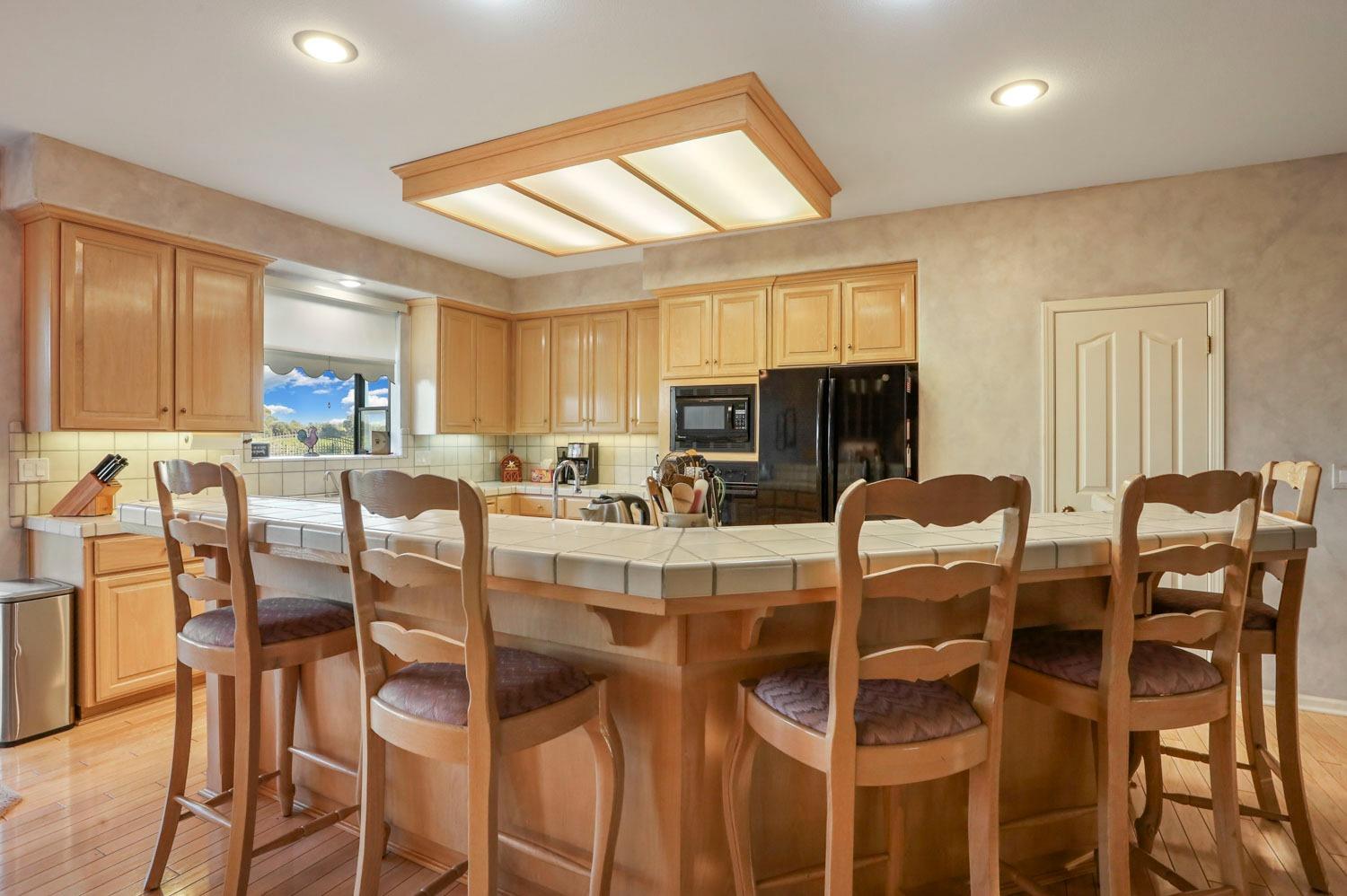 11791 Alpine Road Lodi, CA 95240 - Photo 26 of 74 a dining room with furniture a window and kitchen view