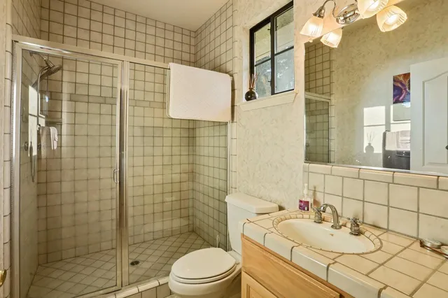 a bathroom with a sink a toilet and a mirror