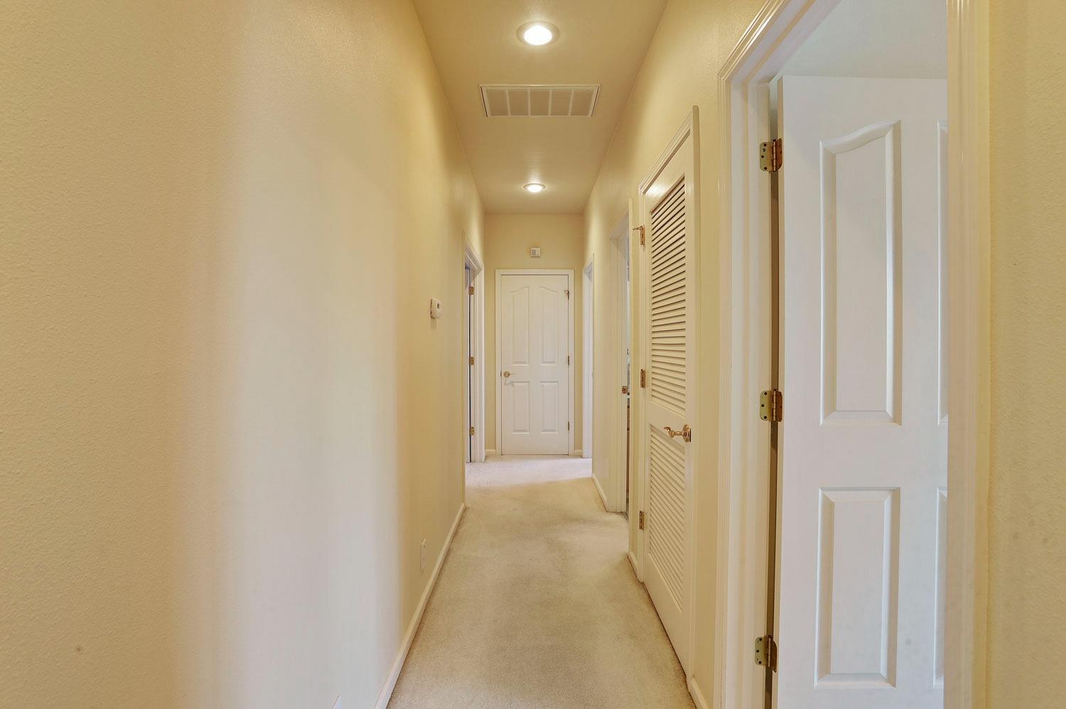 11791 Alpine Road Lodi, CA 95240 - Photo 37 of 74 a view of a hallway with wooden floor
